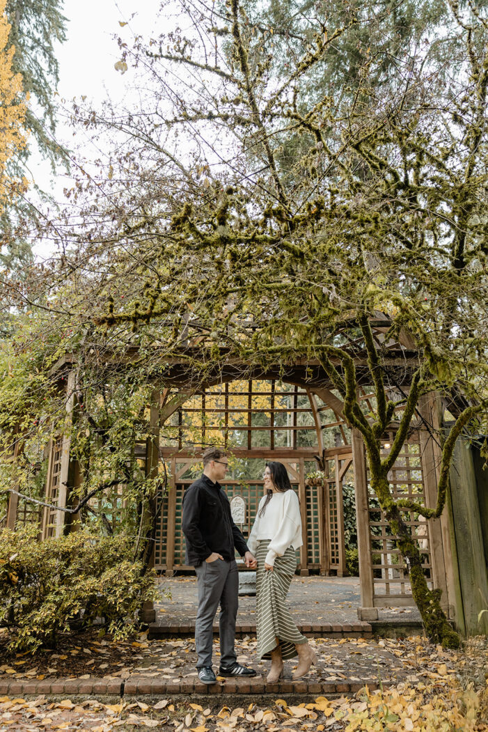 couple stands together in lakewold gardens 
