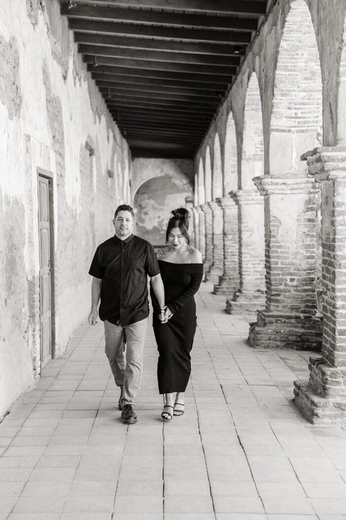 man and woman in black pose at the mission