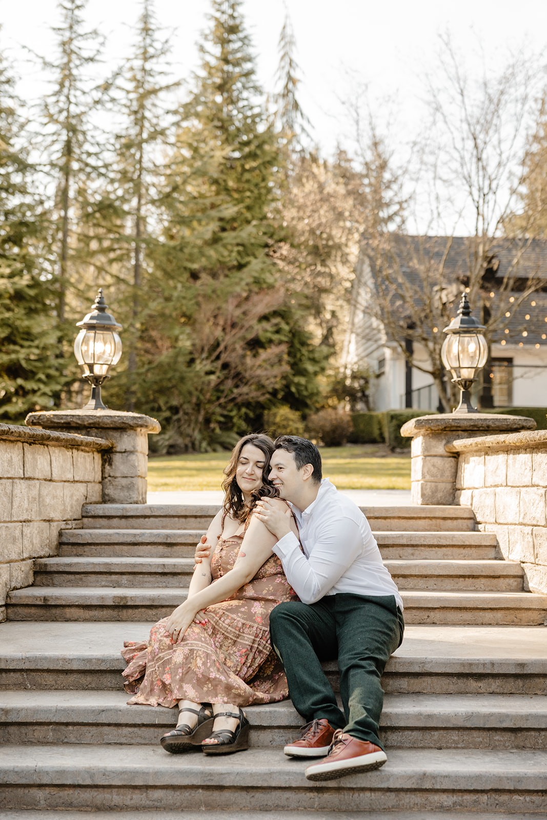man and woman cuddle on garden steps