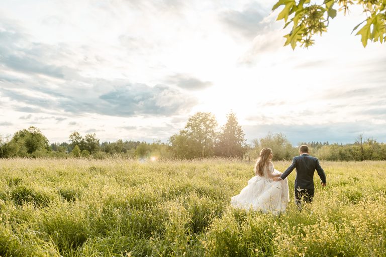 bride and groom in a field together