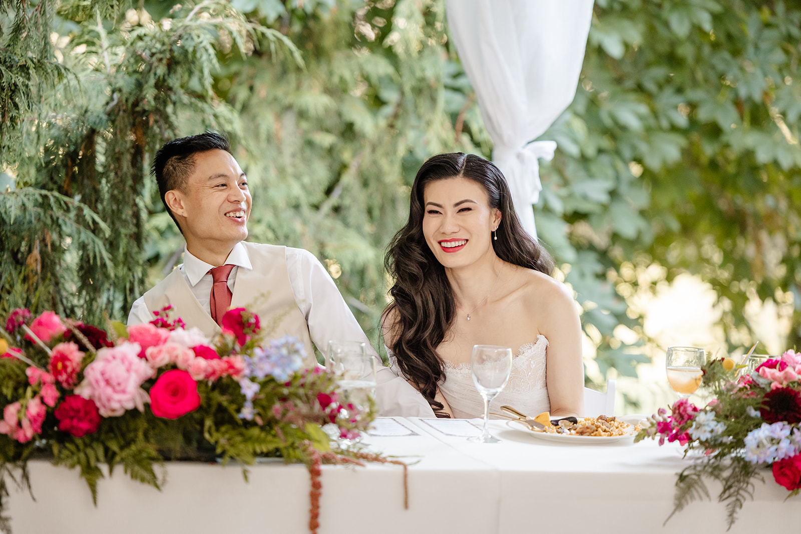 bride and groom laugh at speeches