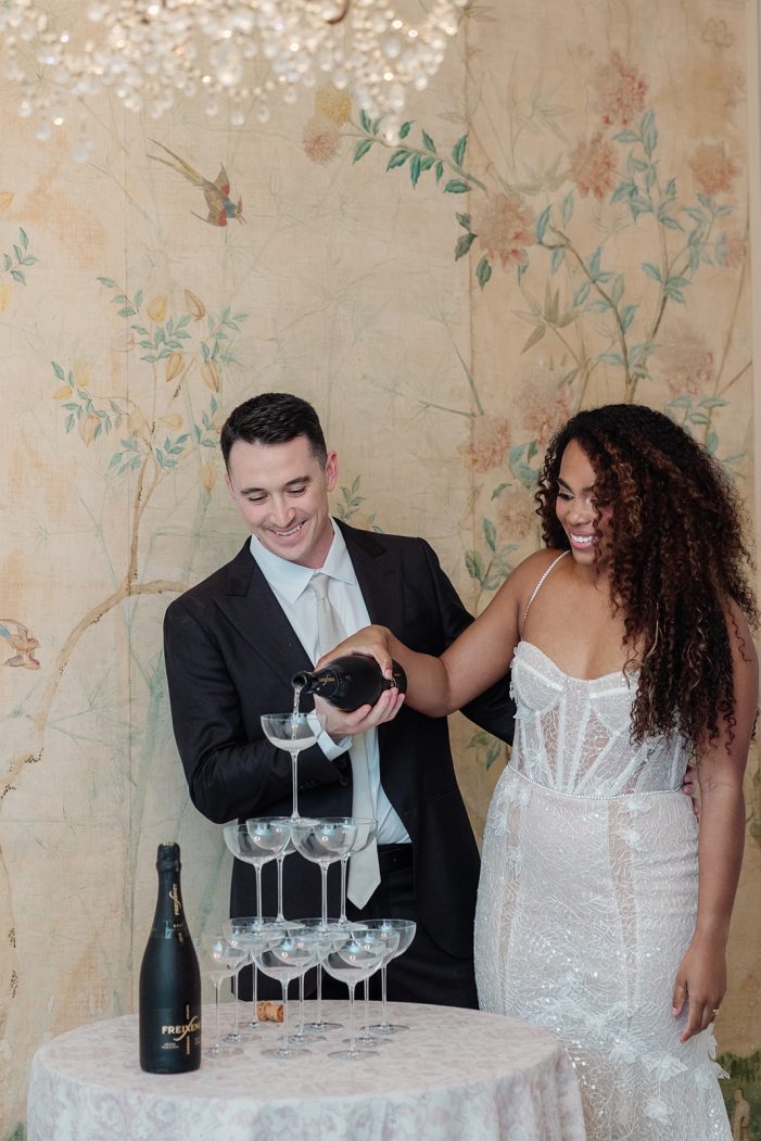 bride and groom at champagne tower