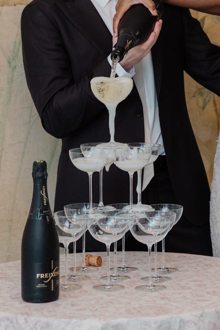 bride and groom at champagne tower