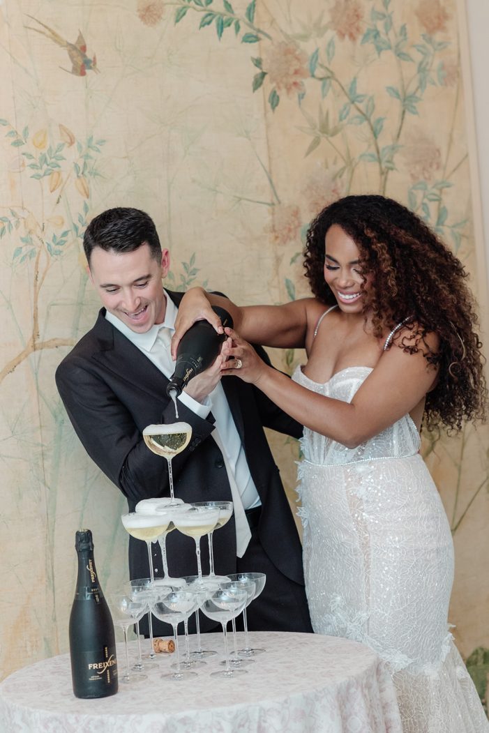 bride and groom at champagne tower