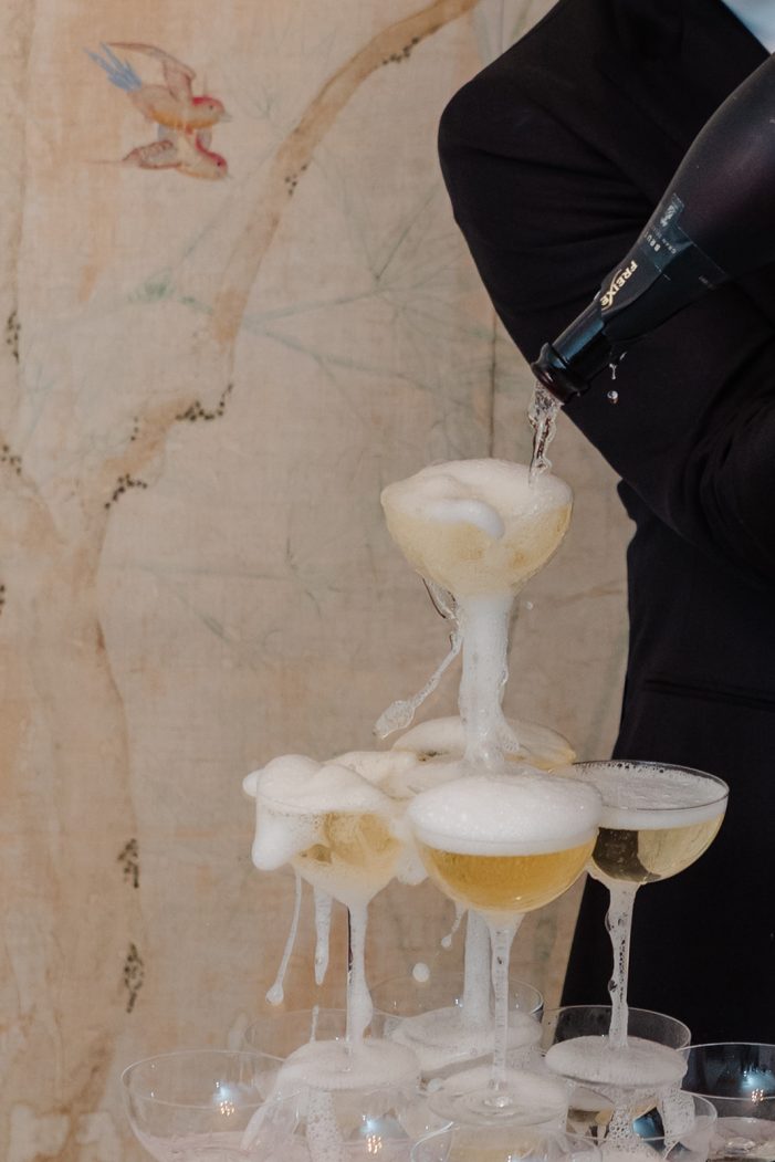 bride and groom at champagne tower