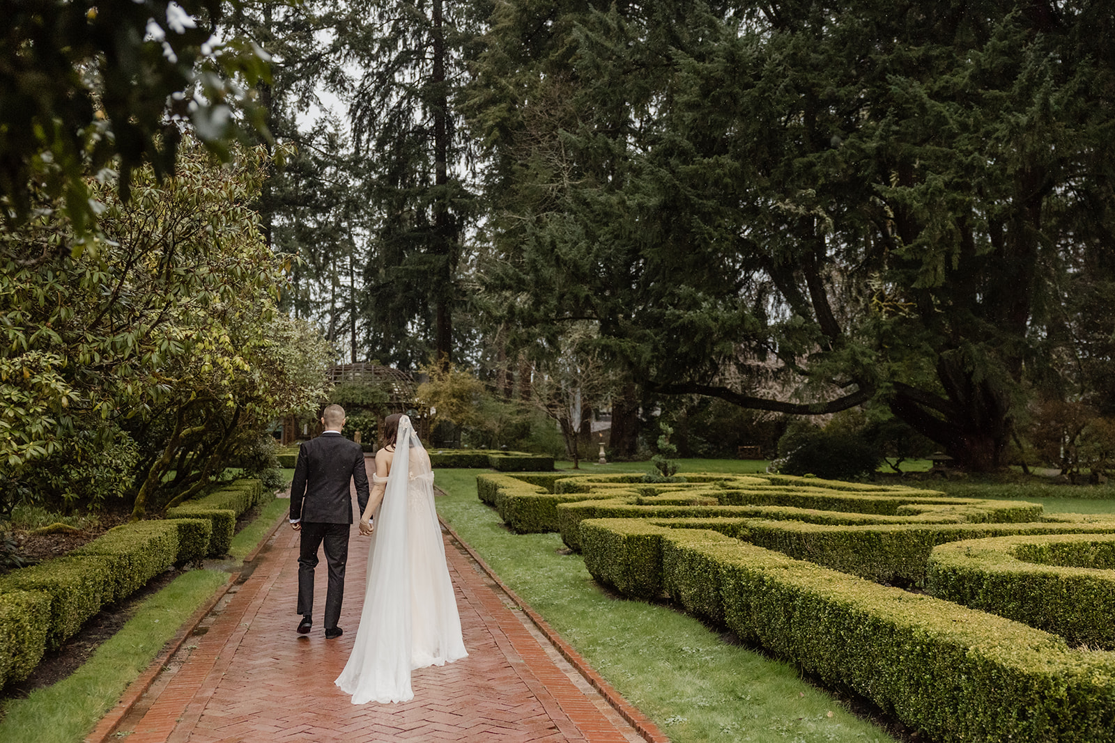 bride and groom walk through lakewold gardens