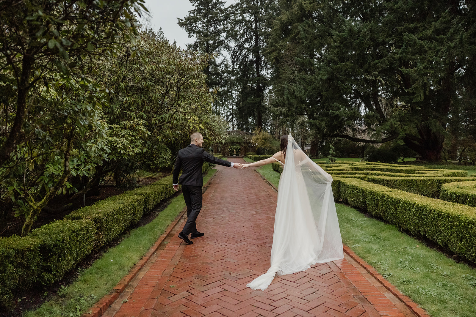 bride and groom walk through lakewold gardens