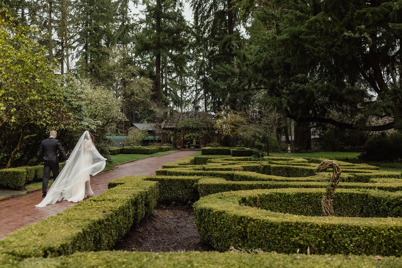 bride and groom walk through lakewold gardens