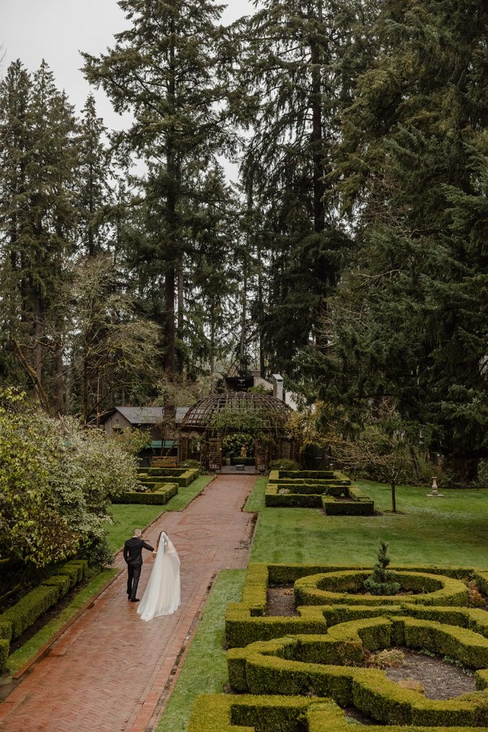 bride and groom walk through lakewold gardens