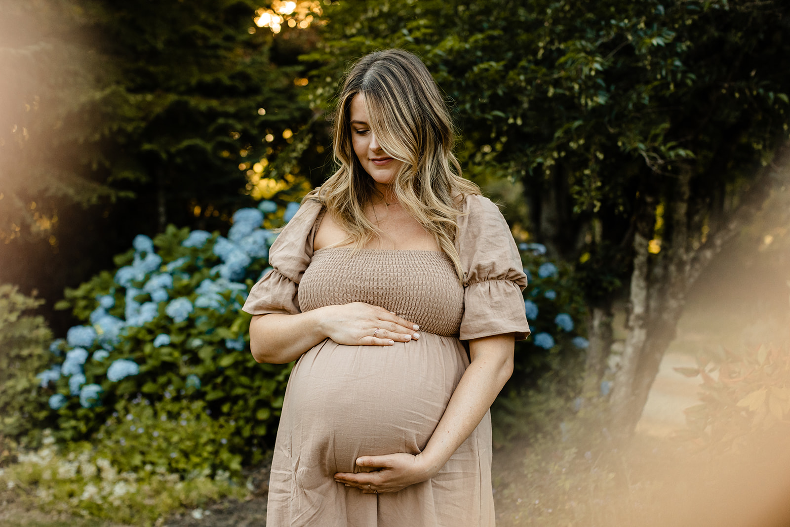 woman cradles pregnant belly