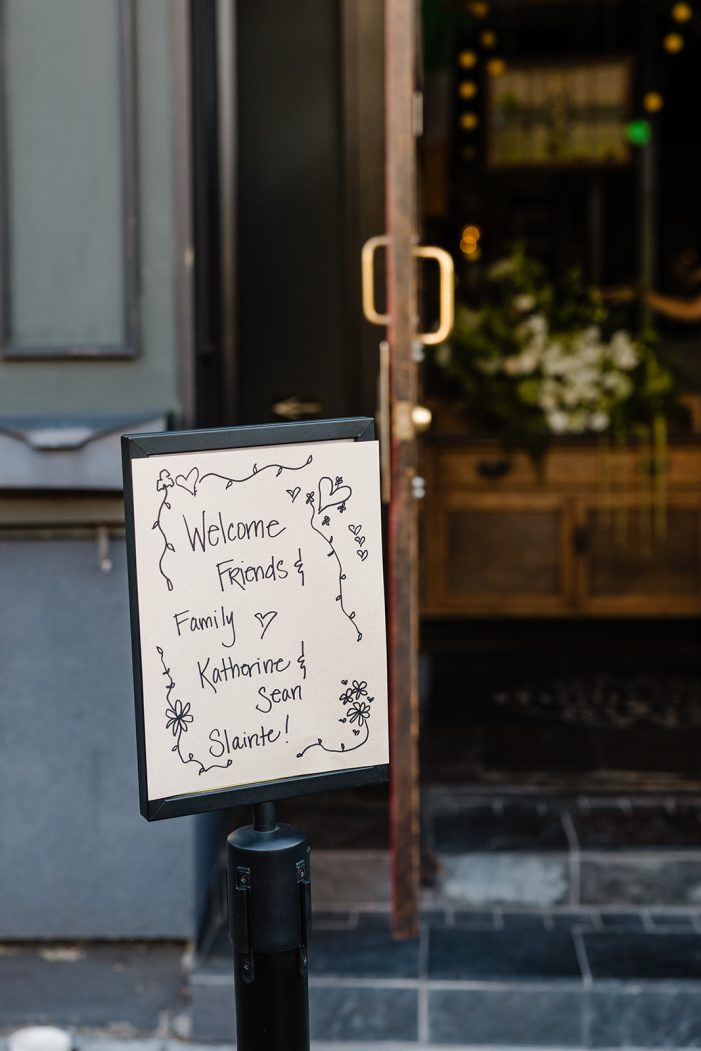 sign with rehearsal dinner information