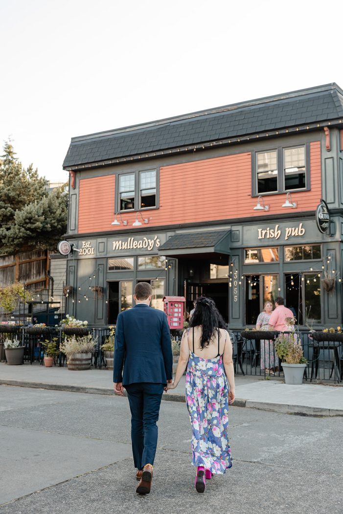 man and woman walk towards irish pub