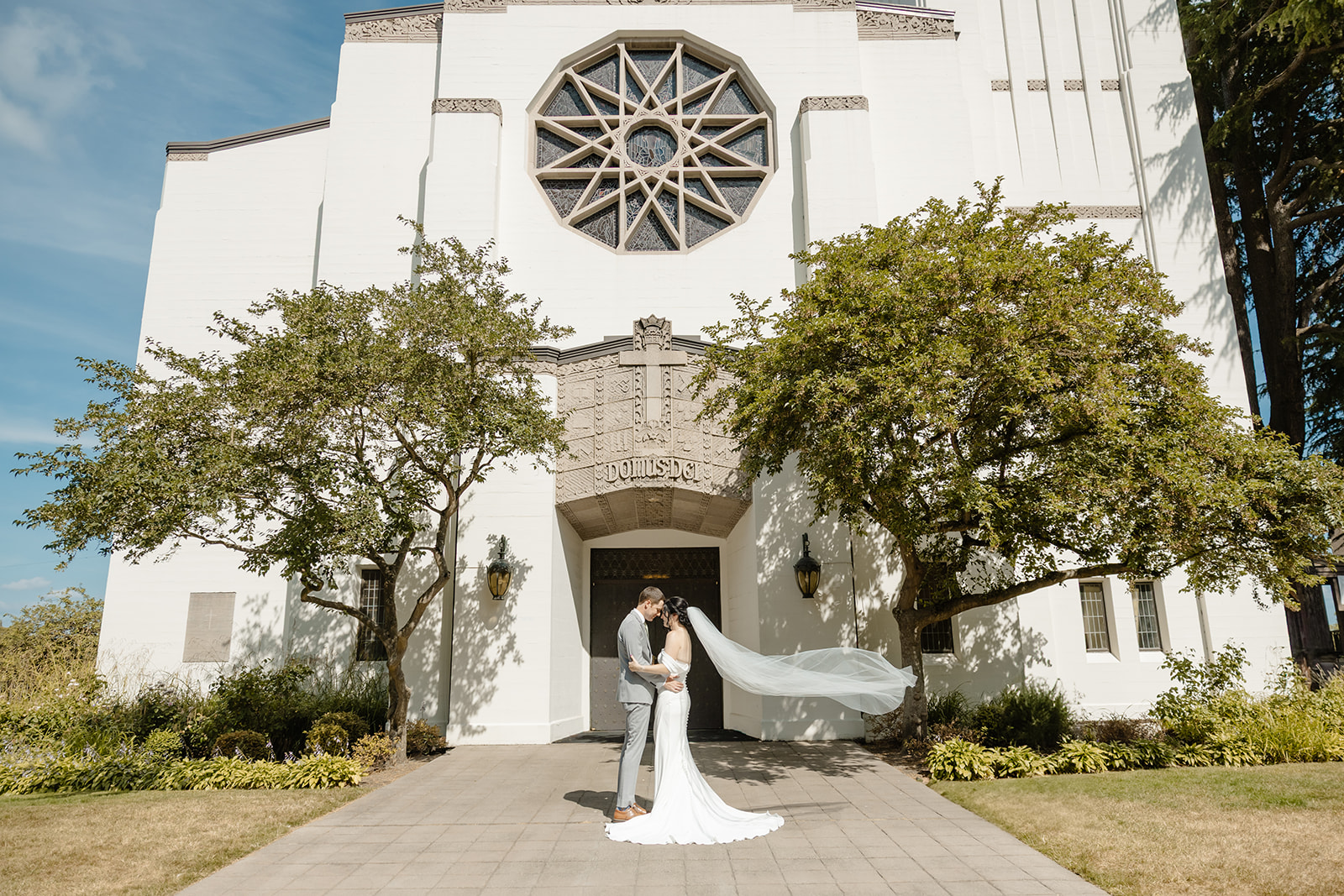 bride and groom in front of church