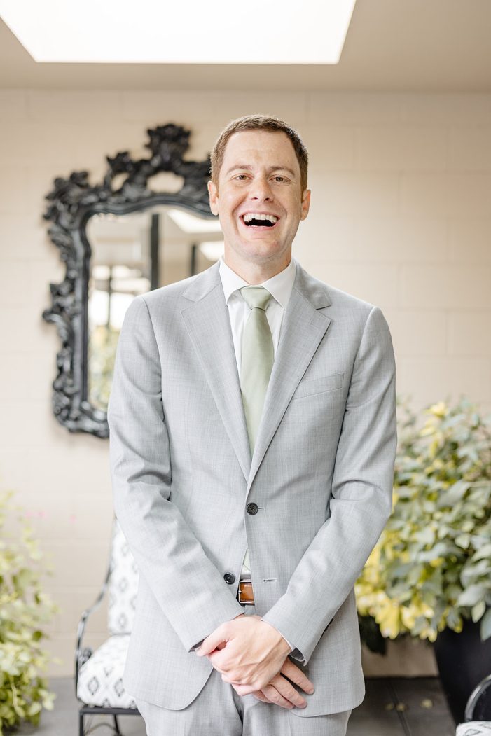 groom laughs at camera