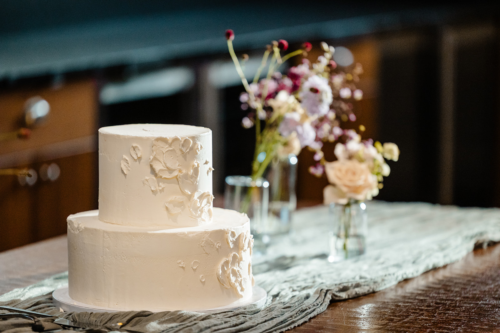 bride and groom cut cake