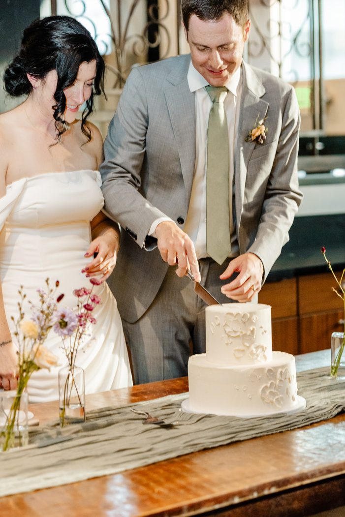 bride and groom cut cake