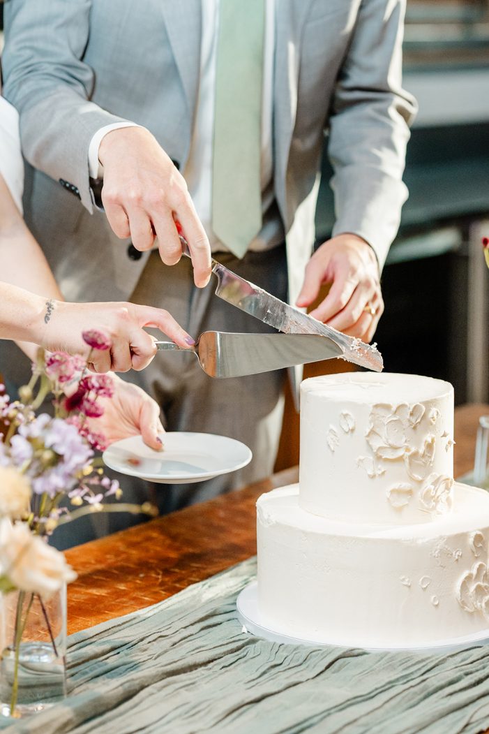 bride and groom cut cake