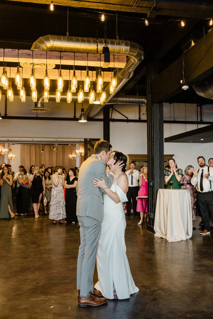 bride and groom kiss on dance floor