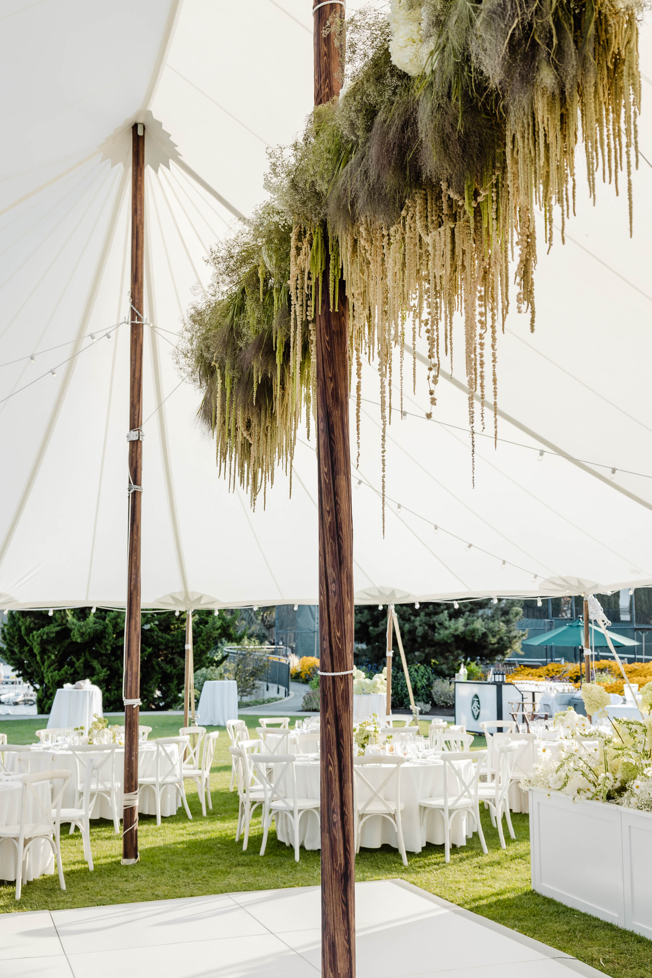 greenery under a lavish tent at seattle tennis club wedding photographer
