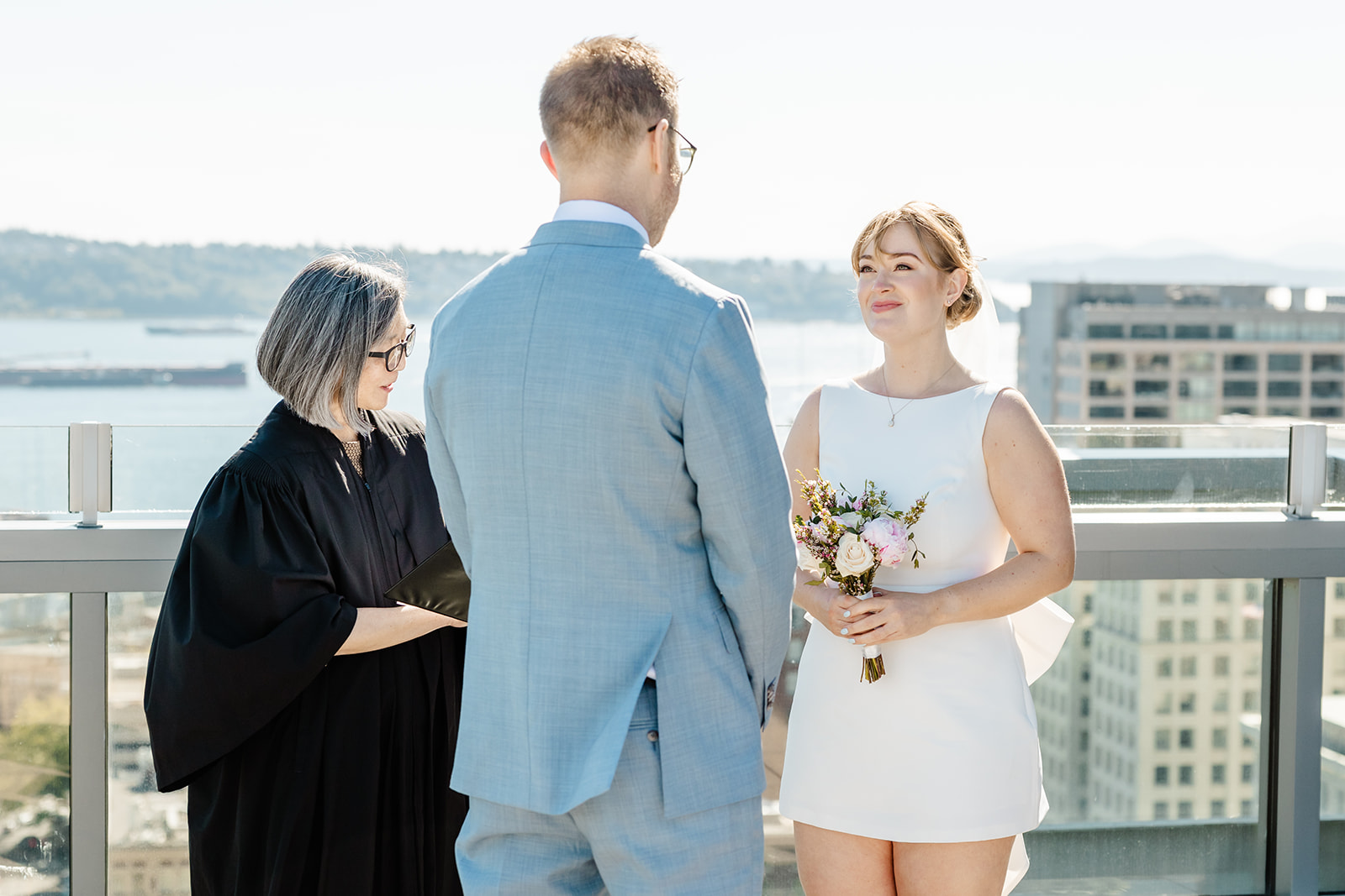 rooftop ceremony seattle courthouse bride looking at her groom