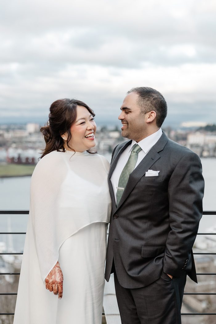 bride and groom with Seattle behind them