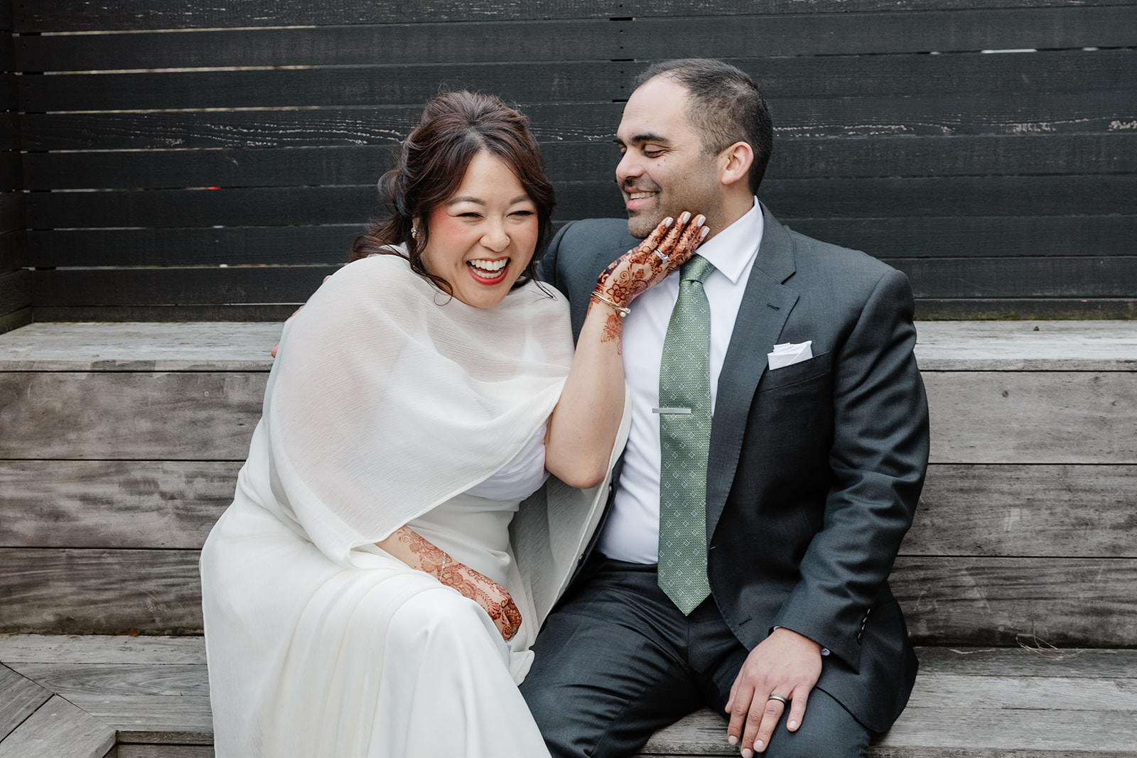 bride and groom laughing together