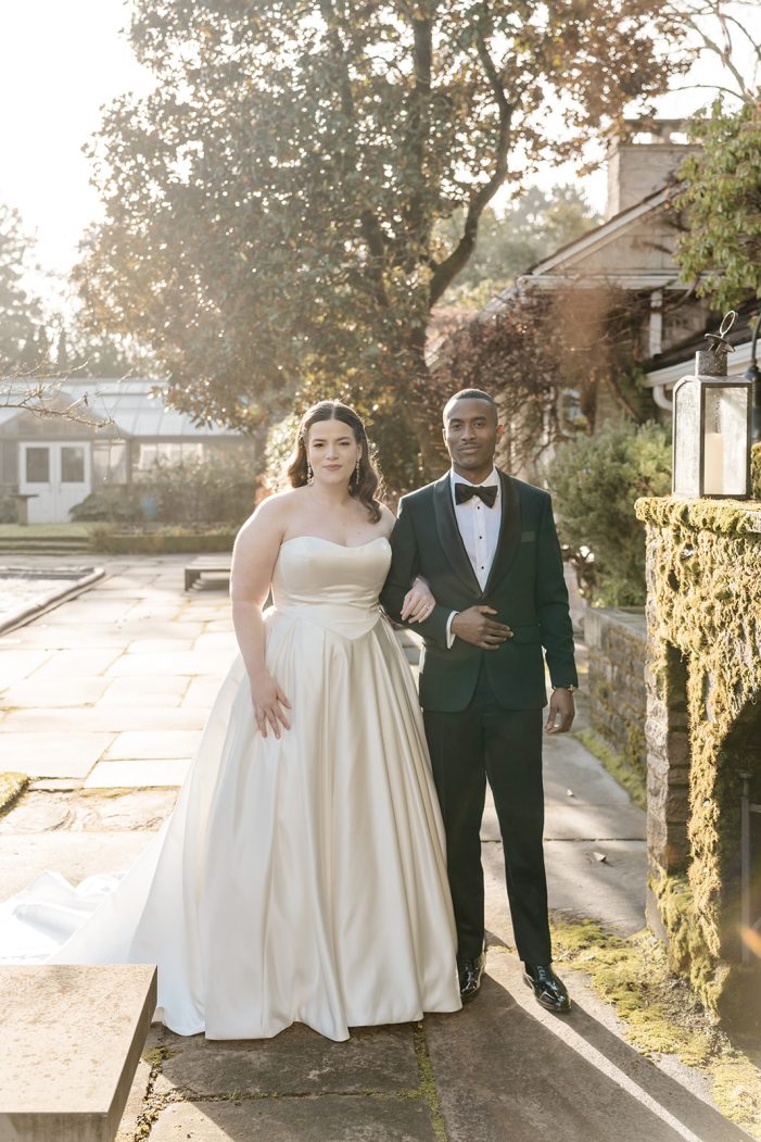 bride and groom outside together in front of fireplace