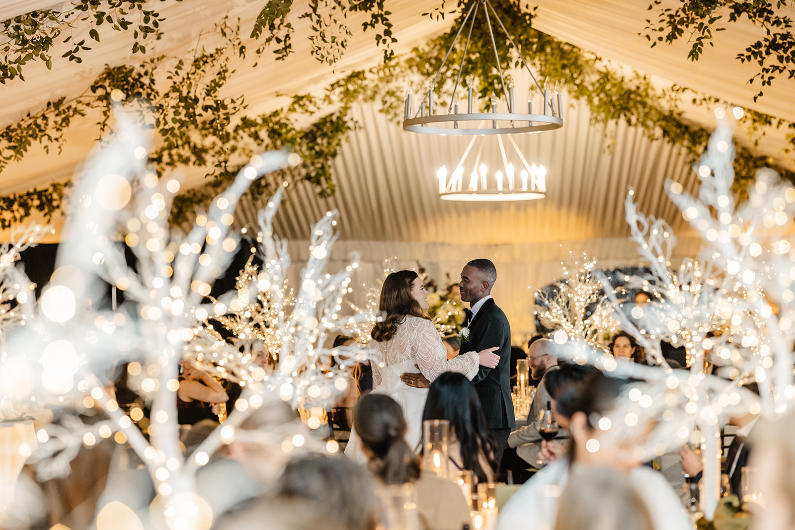 bride and groom dancing surrounded by lights
