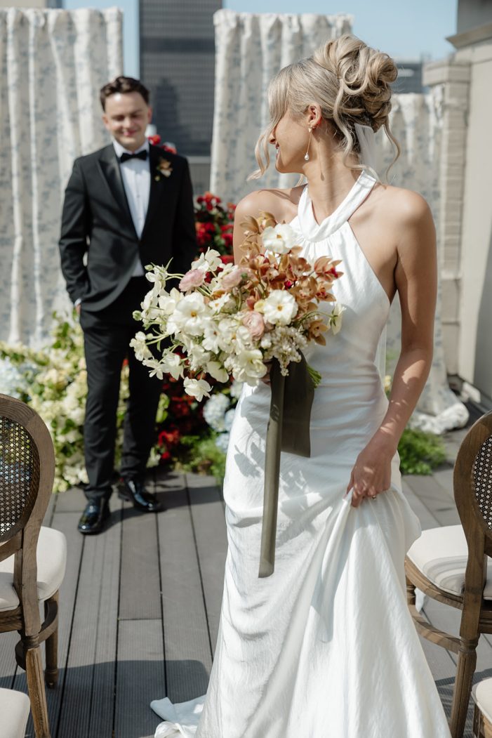 bride looks back at groom over shoulder