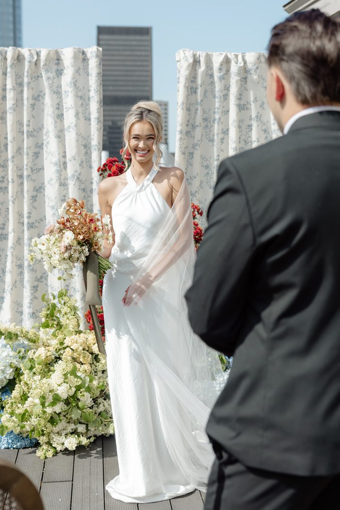 bride smiles at groom and swishes skirt