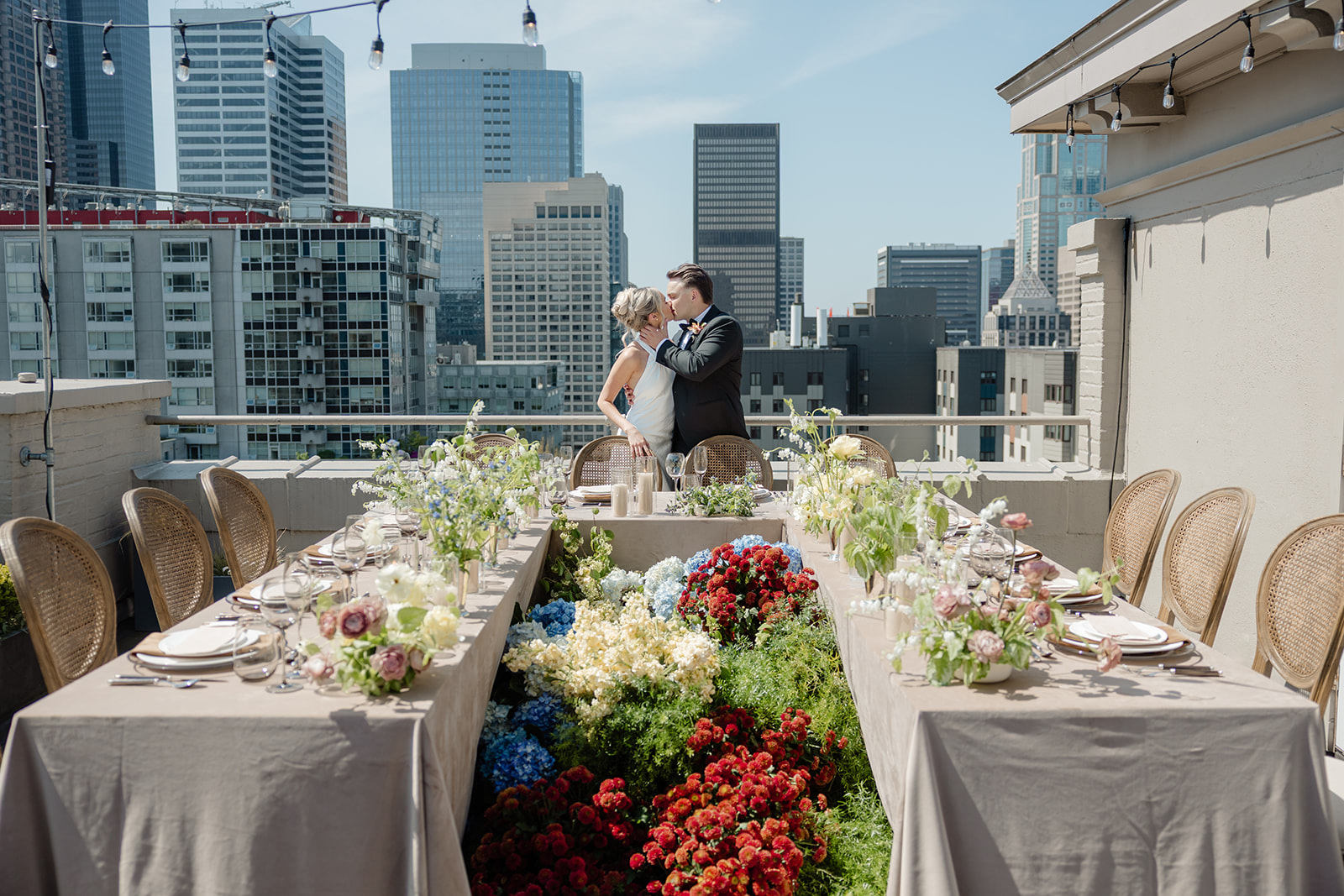 bride and groom at end of table with flowers