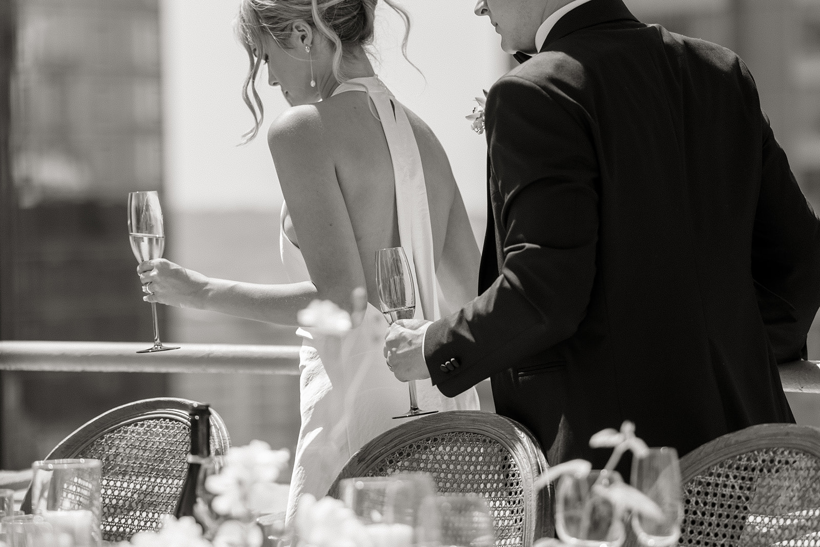 bride and groom walk together past table