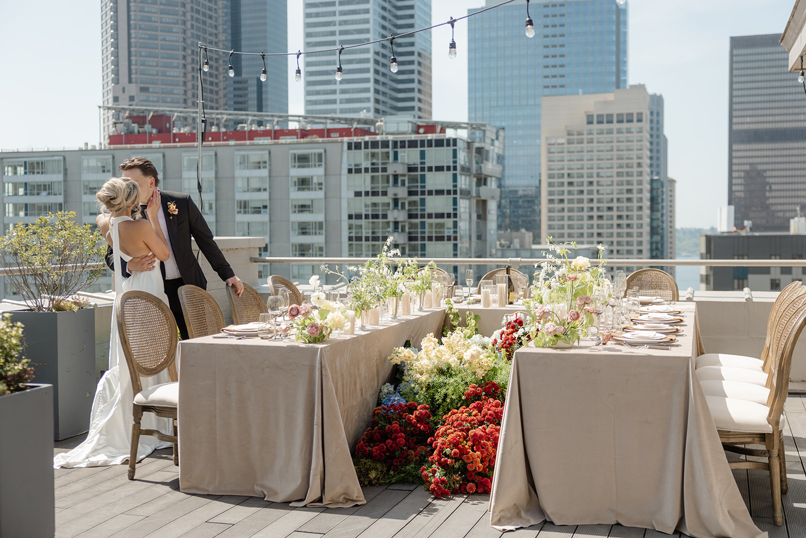 bride and groom kiss beside table