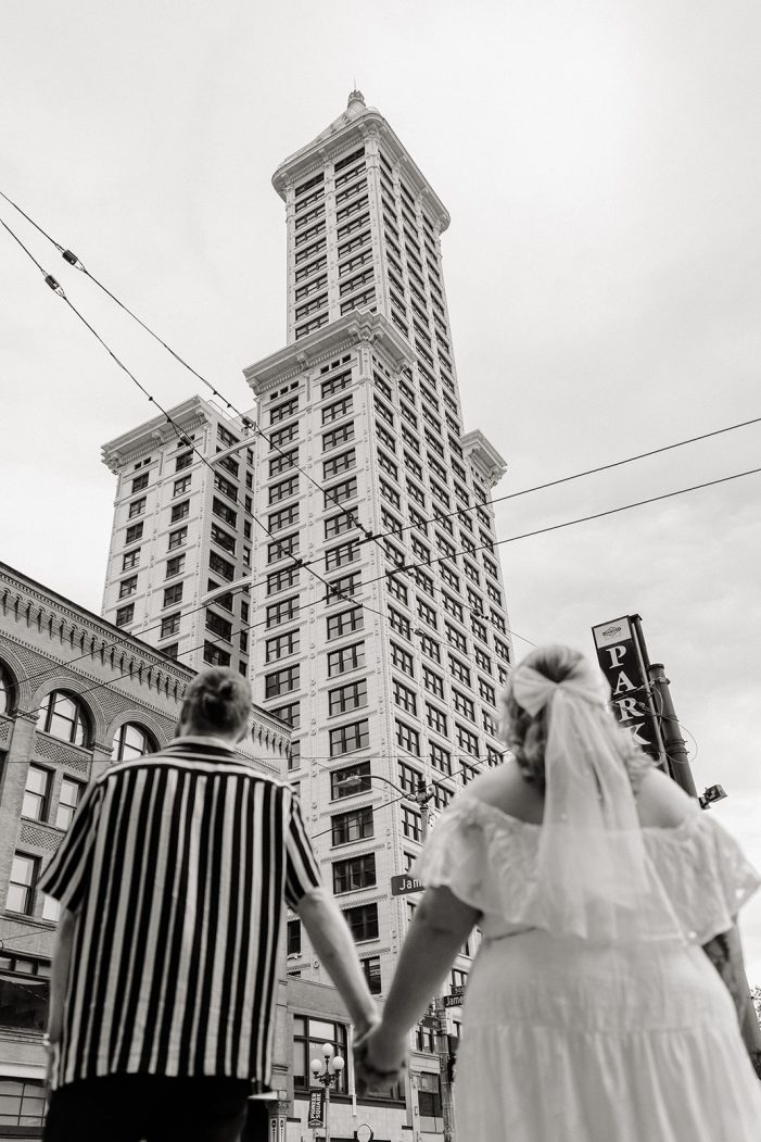 couple looks up at smith tower
