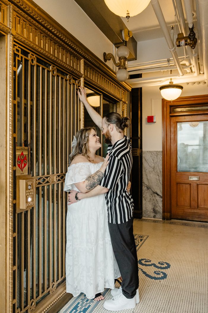 couple snuggles against antique golden gate