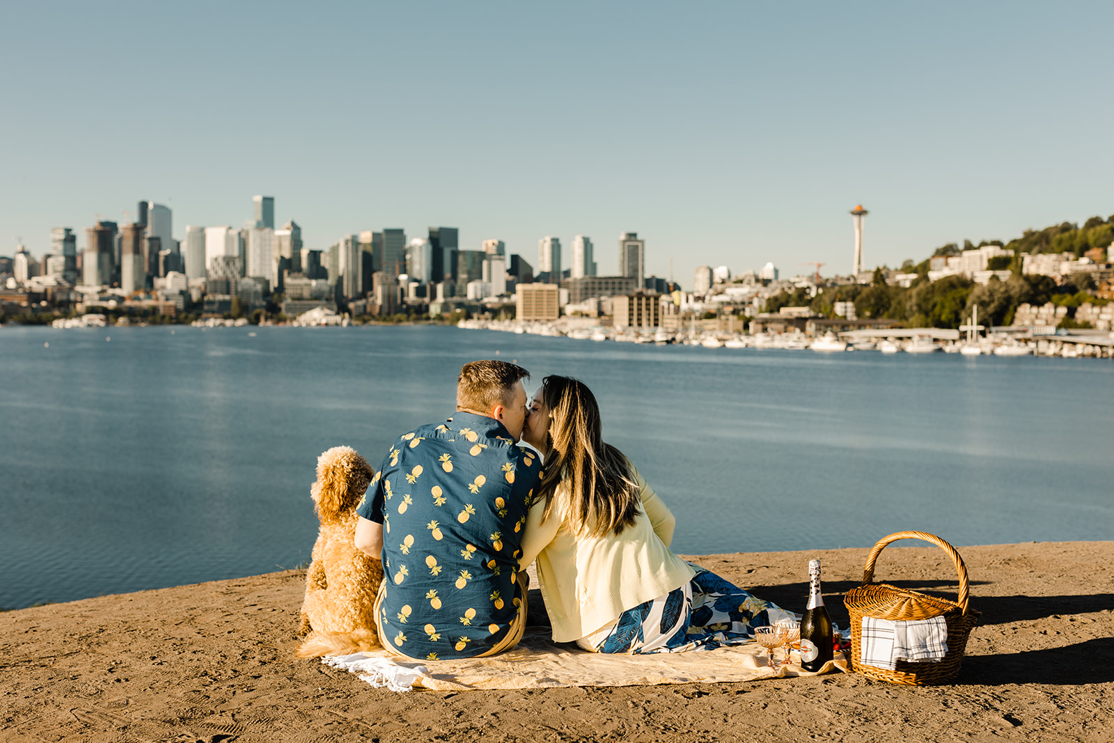 couple sits in front of seattle skyline