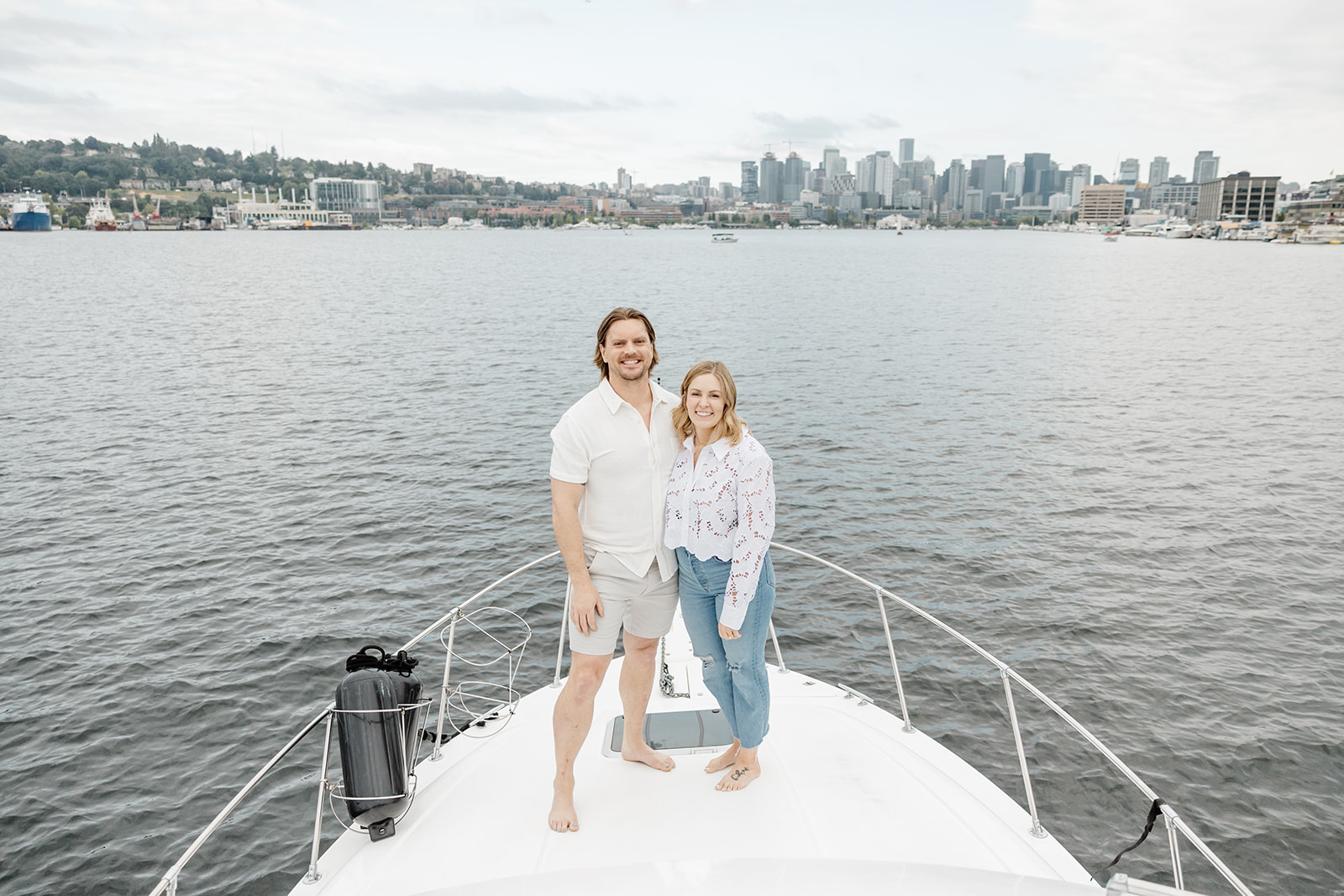 couple stands on bow of boat