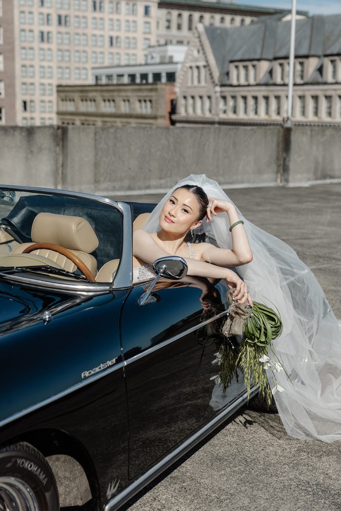 bride hangs out of car
