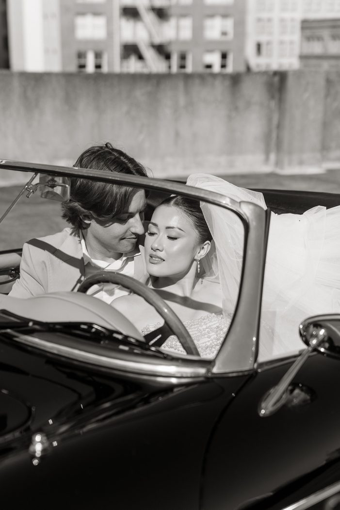 bride and groom cuddle in car