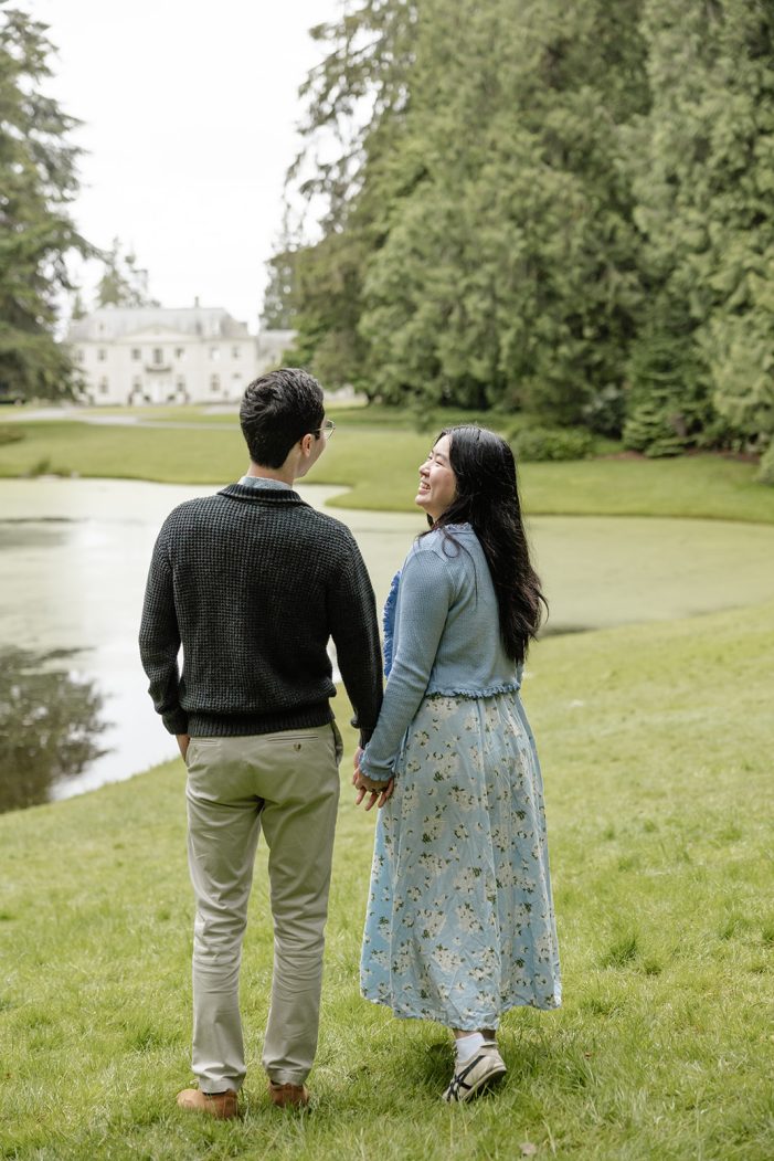 couple walks in grass