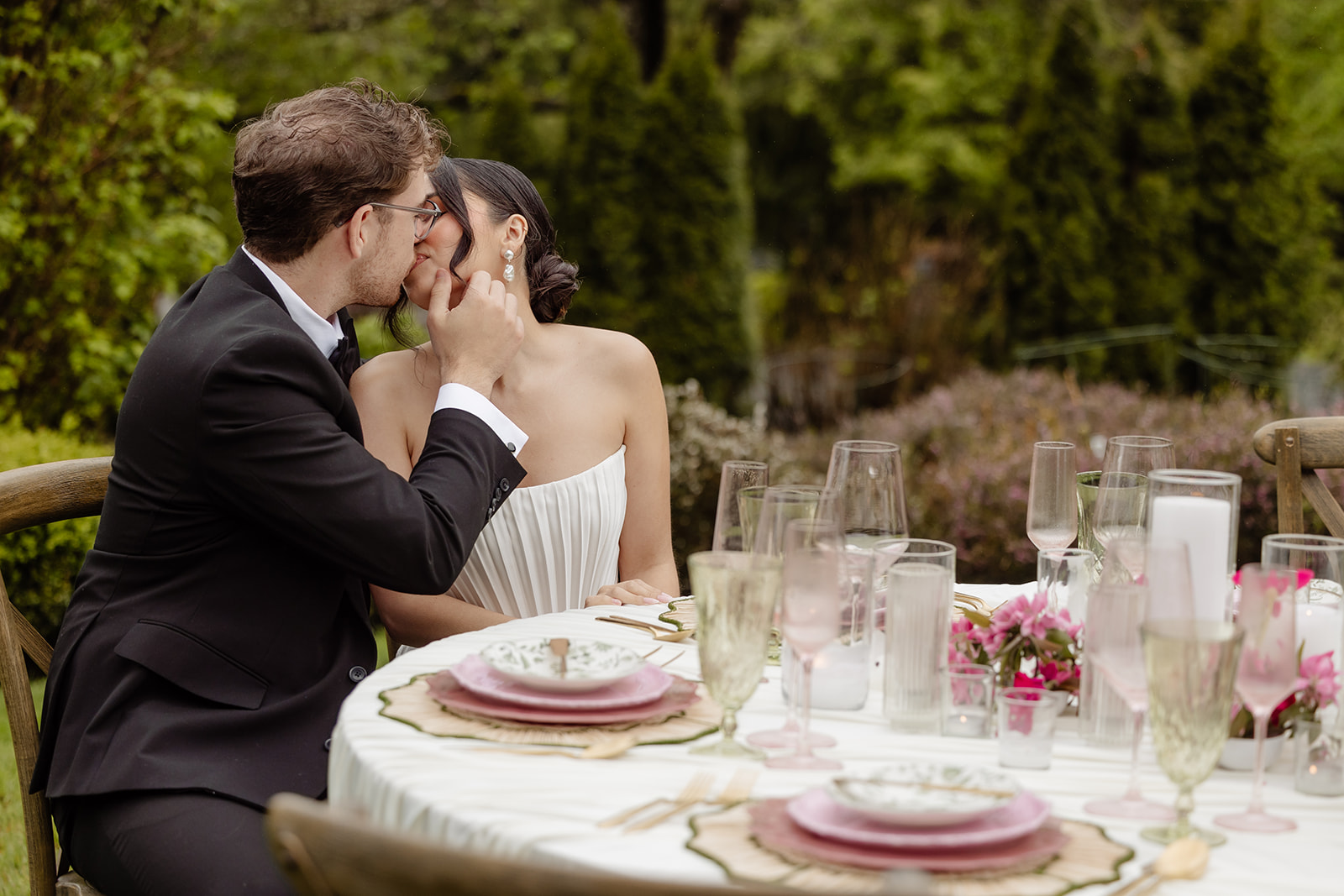 bride and groom kiss at table