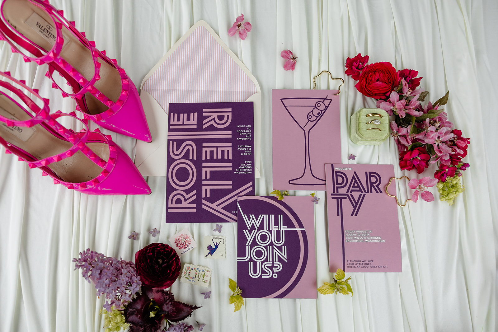 brightly colored flat lay of wedding invites