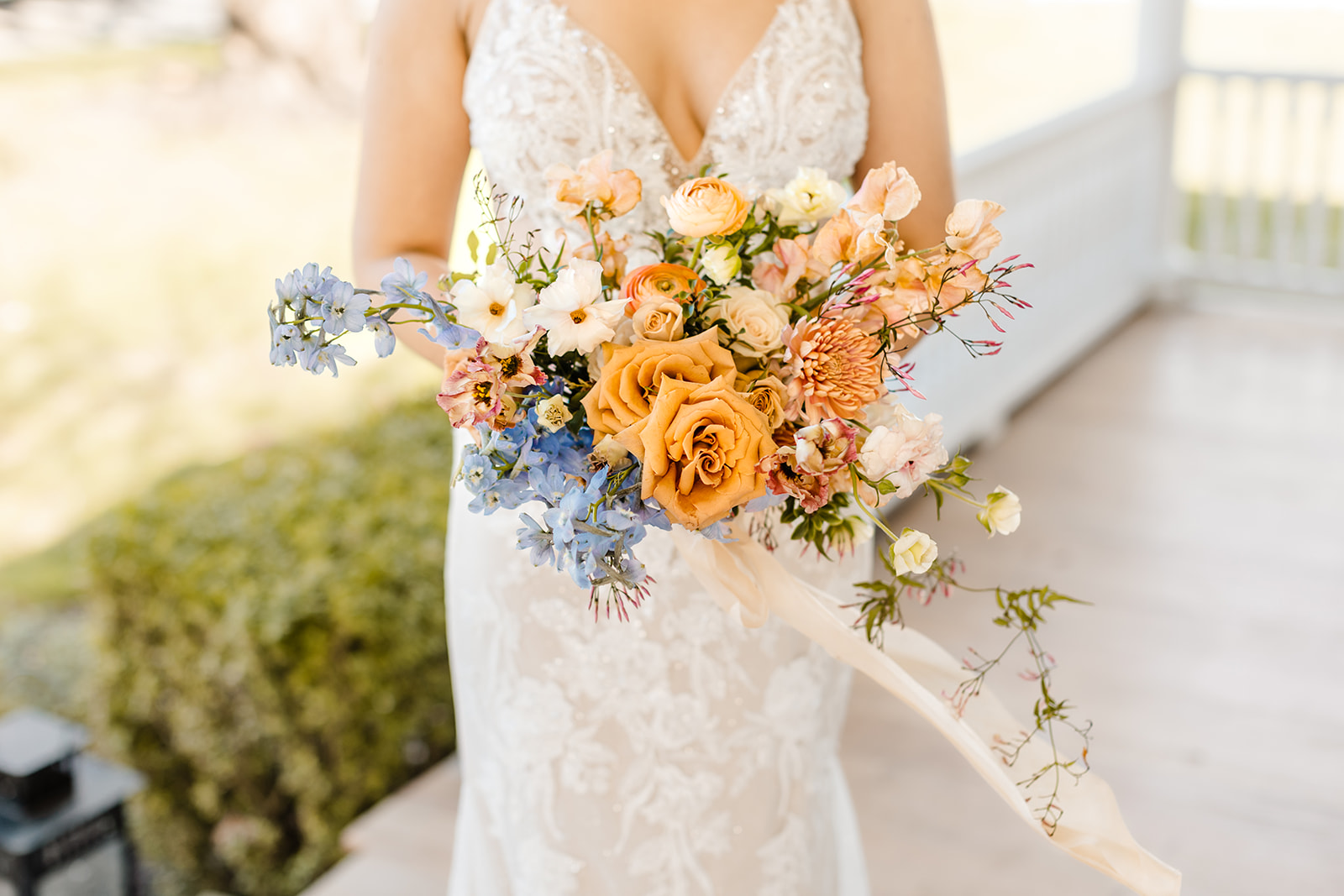 bride holds bouquet in front of her