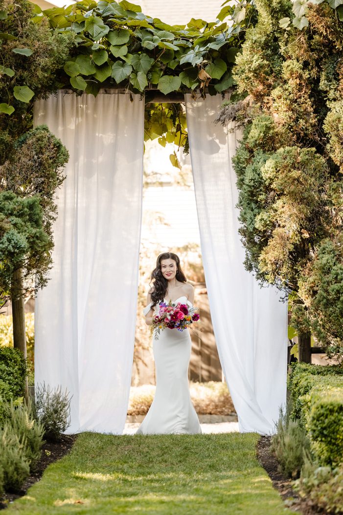 bride walks out from behind curtain