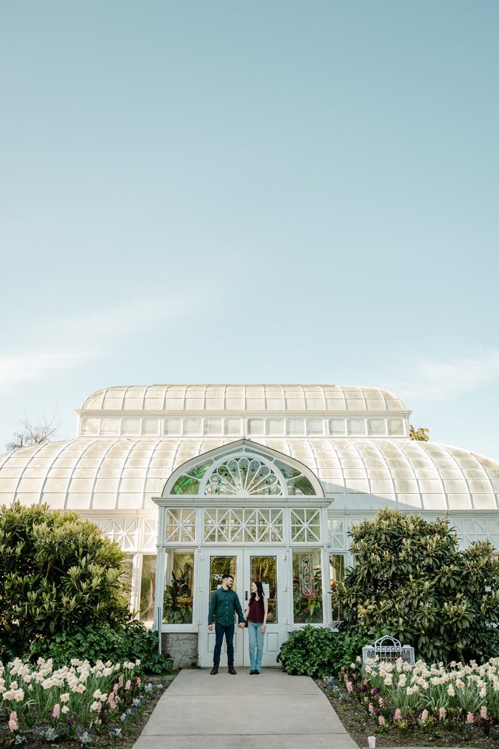 man and woman in front of greenhouse