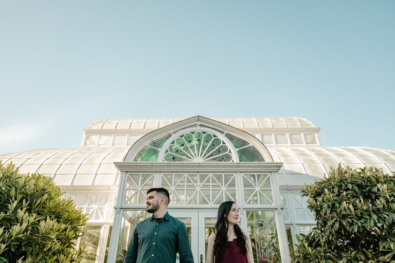 man and woman in front of greenhouse