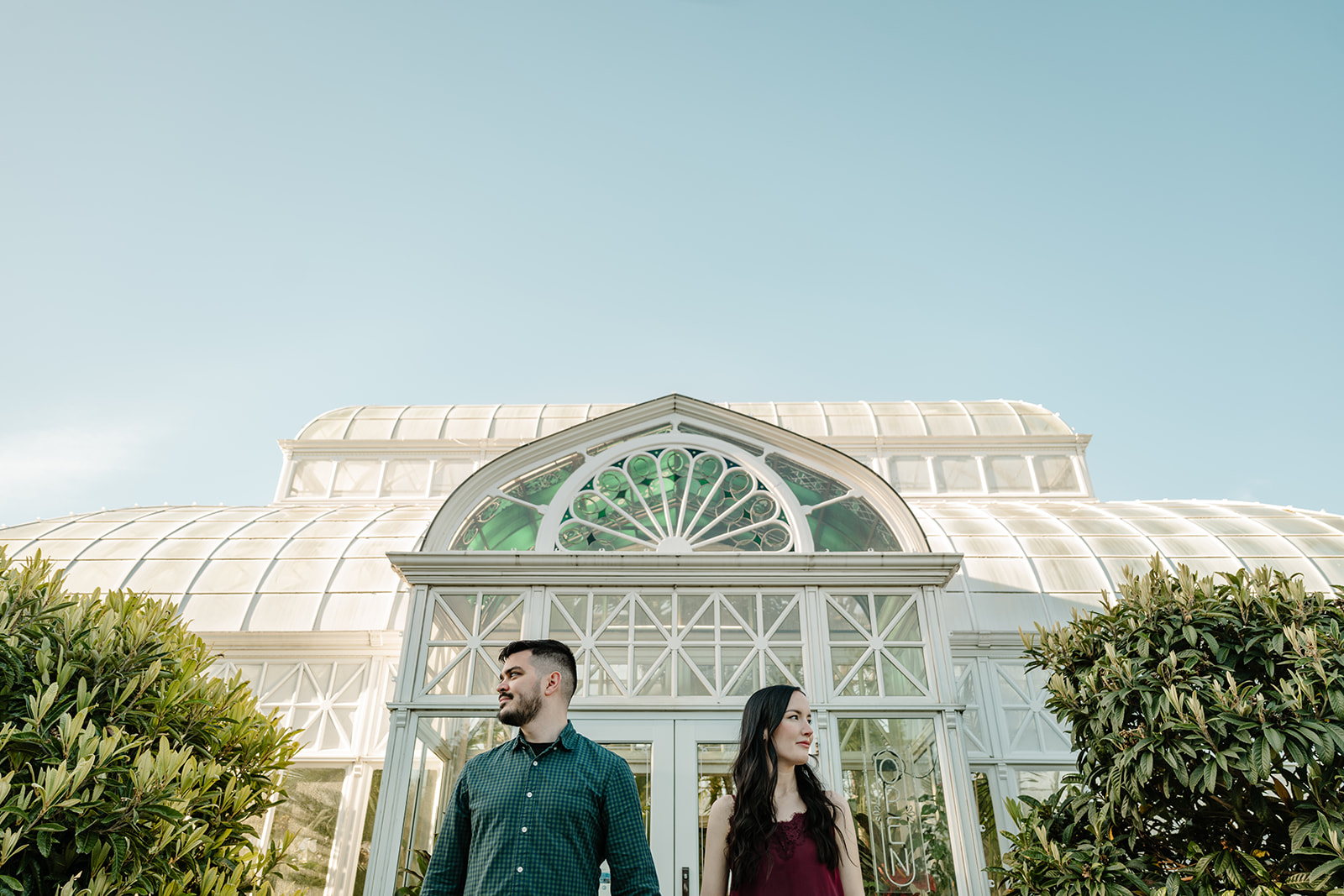 man and woman in front of greenhouse