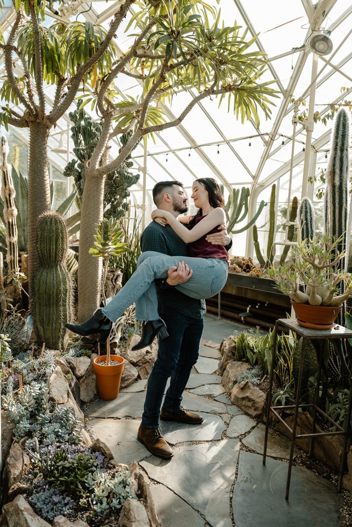 man and woman in greenhouse