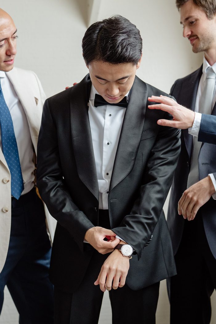 groom gets dressed in suit