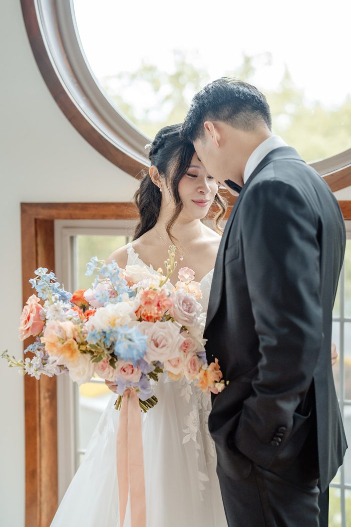 bride and groom stand together